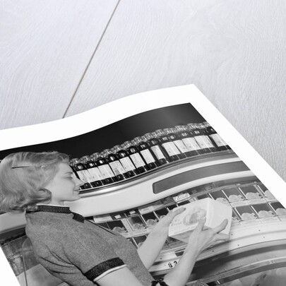 Blond woman selecting ice cream frozen food section supermarket by Anonymous