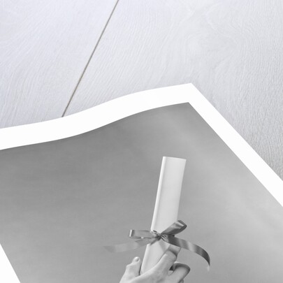 Male hand holding graduation diploma by Anonymous