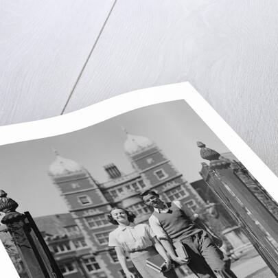 College aged student couple walking through campus gates university of pennsylvania by Anonymous