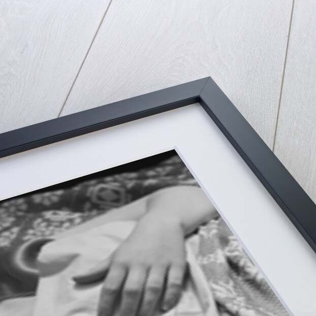 Sleeping blond woman hand over head asleep by Anonymous