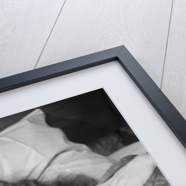 Woman sleeping asleep in bed alarm clock on night table by Anonymous