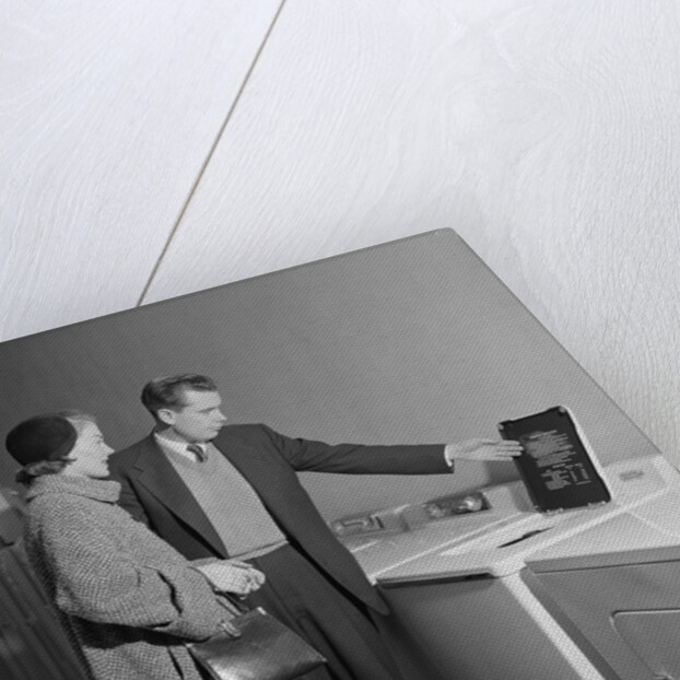 Young couple man woman shopping for washing machine by Anonymous
