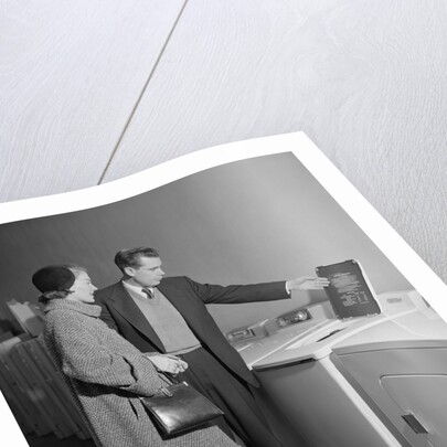 Young couple man woman shopping for washing machine by Anonymous