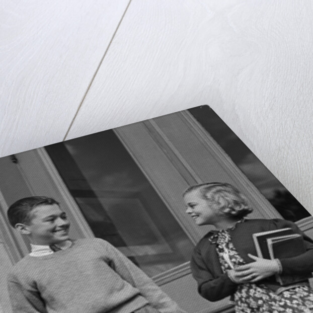 Smiling boy & girl holding school books by doors by Anonymous