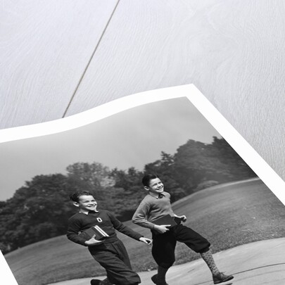 Two smiling boys running carrying school books by Anonymous