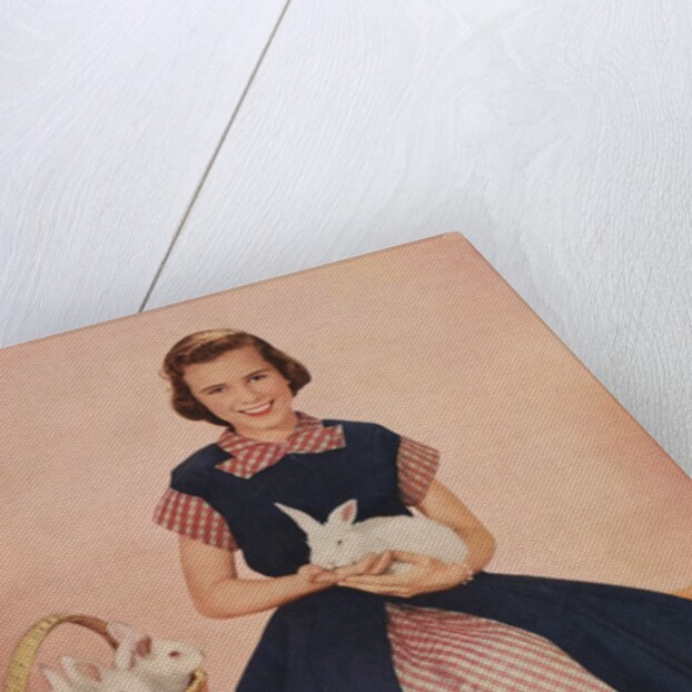 Girl holding rabbit by Anonymous