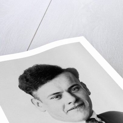 Young man smiles in a formal portrait, ca. 1920 by Anonymous