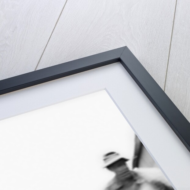 Farmer is a blur of activity working on his tractor, ca. 1938 by Anonymous