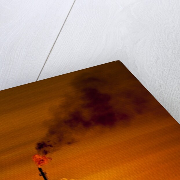 Flames and smoke billow from natural gas flare at Valero Oil Refinery at sunset by Anonymous