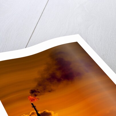 Flames and smoke billow from natural gas flare at Valero Oil Refinery at sunset by Anonymous