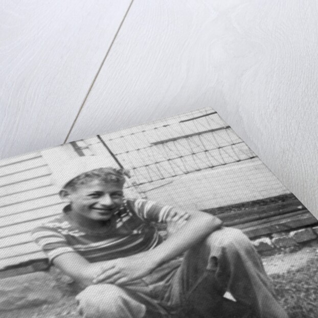 Boy sitting a very small wagon, ca. 1938 by Anonymous