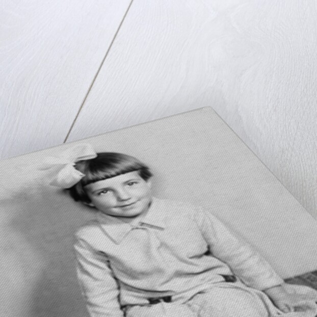 Young girl sits on a sofa, ca. 1933 by Anonymous