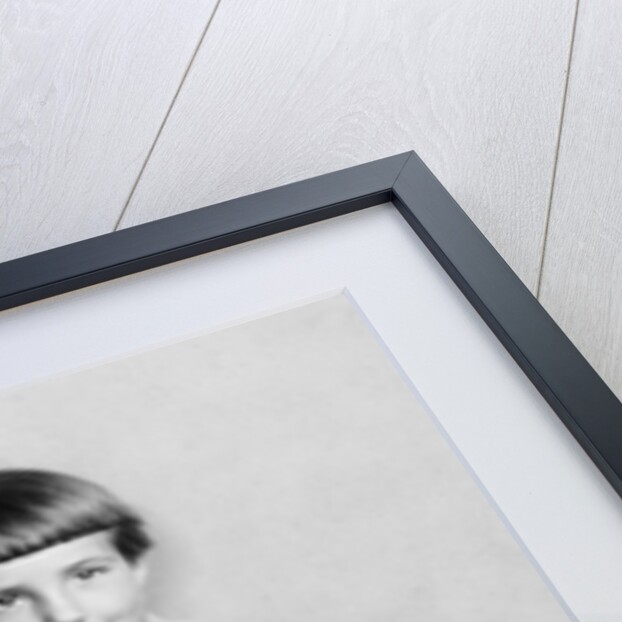 Young girl sits on a sofa, ca. 1933 by Anonymous