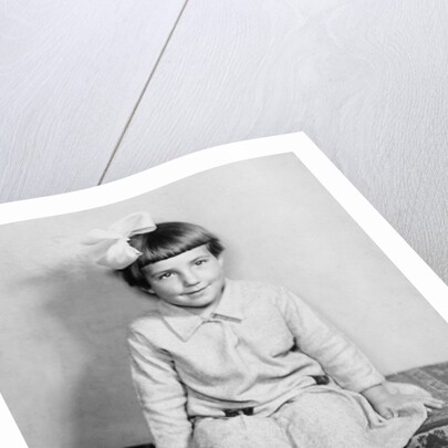 Young girl sits on a sofa, ca. 1933 by Anonymous