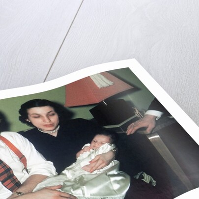 Young couple holding baby boy in christening gown, ca. 1952 by Anonymous