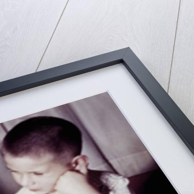 Brother watches his sister blow out candles on birthday cake, ca. 1956 by Anonymous