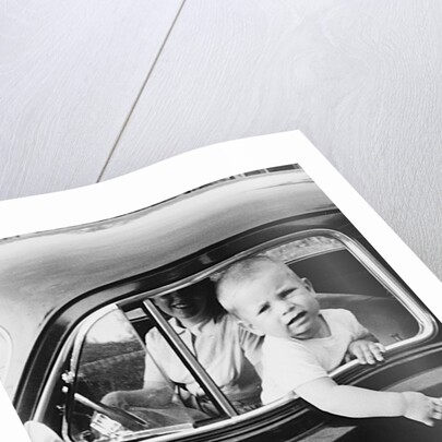 Young boy hangs out of driver's side car window, ca. 1954 by Anonymous