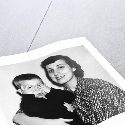 Mother holding son playing peek-a-boo, ca. 1955 by Anonymous