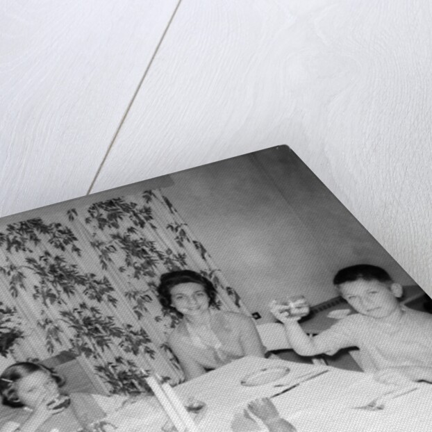 Mother with children at the dinner table, ca. 1962 by Anonymous