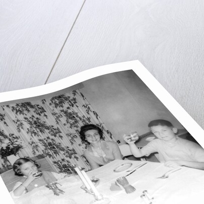 Mother with children at the dinner table, ca. 1962 by Anonymous