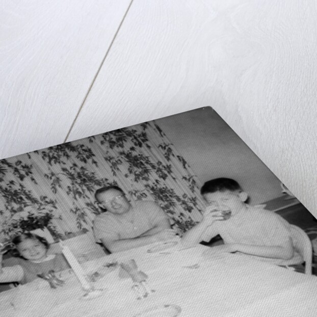 Father with children at the dinner table, ca. 1962 by Anonymous