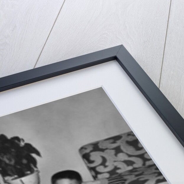 Mother with son and daughter in living room, ca. 1960 by Anonymous