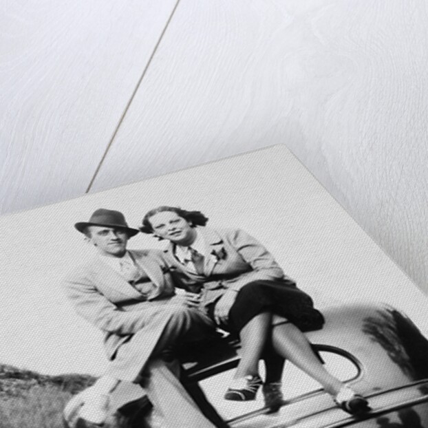 Couple proudly sits on their new car, ca. 1935 by Anonymous