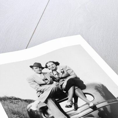 Couple proudly sits on their new car, ca. 1935 by Anonymous