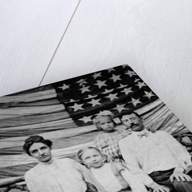 Family pose in front of American Flag, ca. 1898 by Anonymous