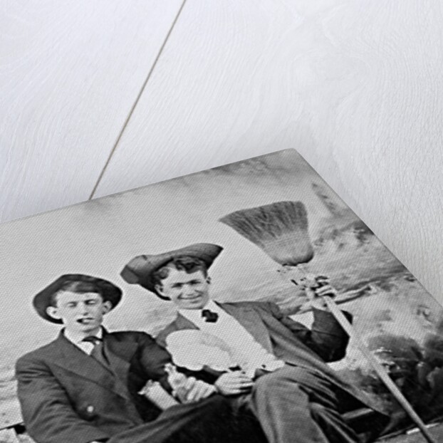 Two young men on a bench with a broom, ca. 1900 by Anonymous