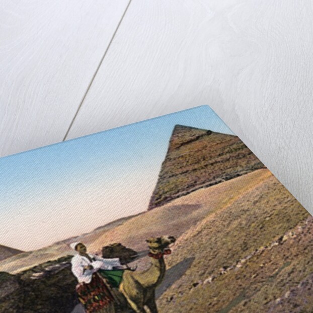 Man riding a camel in front of the Sphinx and pyramids by Anonymous