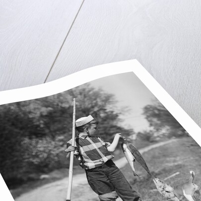 1950s boy plaid shirt sailor hat fishing pole dog pulling on tail of caught fish by Anonymous