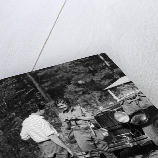 1920s 1930s couple man woman in fishing gear holding poles standing in front of packard touring automobile by Anonymous