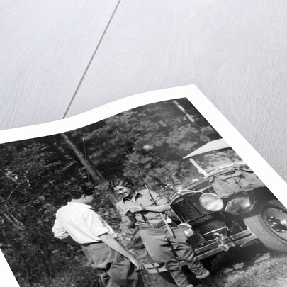 1920s 1930s couple man woman in fishing gear holding poles standing in front of packard touring automobile by Anonymous