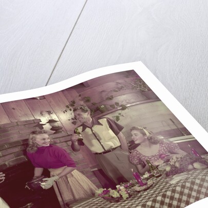 1950s 2 couples cooking picnic in rustic kitchen drinking beer by Anonymous