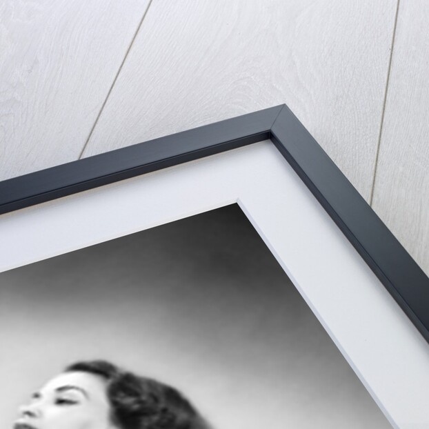 1950s young woman wearing sexy lingerie kneeling on leopard skin holding fluffy dog by Anonymous