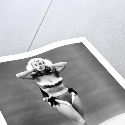 1950s young woman standing inside wearing fur trimmed bikini and gloves by Anonymous