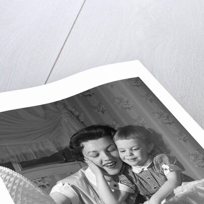 1950s mother & daughter admiring baby in bassinet by Anonymous
