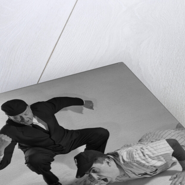 1950s baseball umpire calling sliding player out studio shot by Anonymous