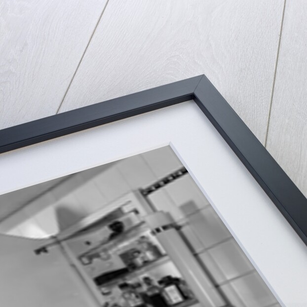 1940s woman wearing blindfold reaching into bathroom medicine cabinet by Anonymous