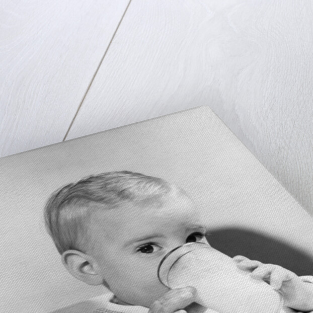1950s boy toddler drinking glass milk looking at camera by Anonymous
