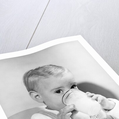 1950s boy toddler drinking glass milk looking at camera by Anonymous
