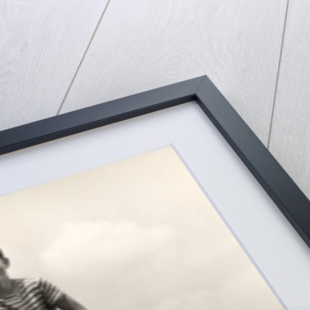 1930s 1940s smiling happy boy wearing striped shirt & short pants walking on pair of stilts looking at camera by Anonymous