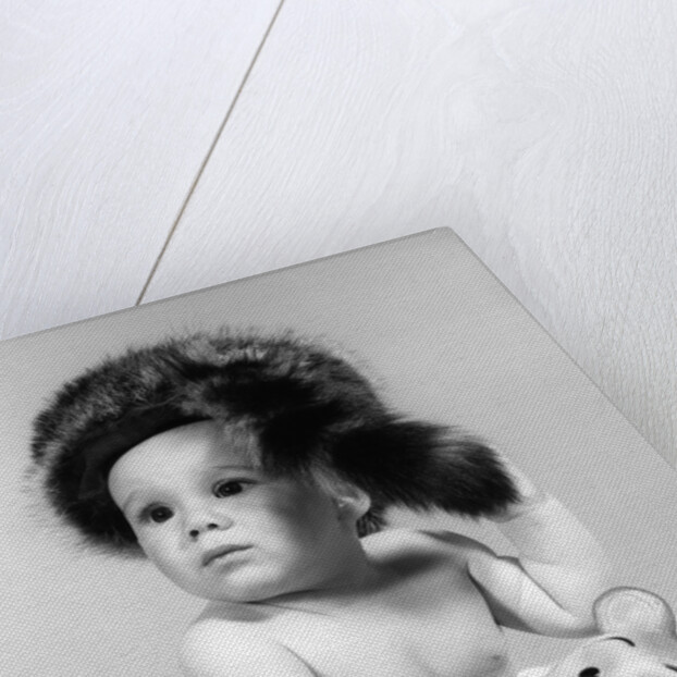 1960s baby wearing coonskin hat by Anonymous