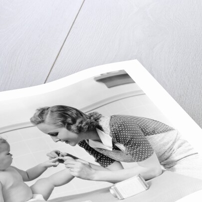 1930s mother touching baby toes fingers this little piggy nursery rhyme by Anonymous