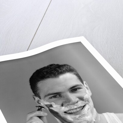 1940s smiling man shaving wearing tee shirt by Anonymous