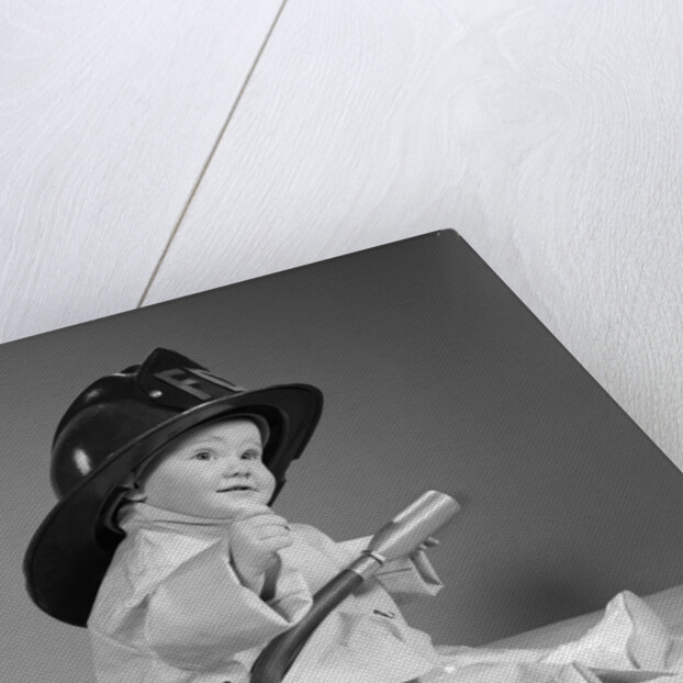 1960s baby fireman with safety hat coat and fire extinguisher by Anonymous