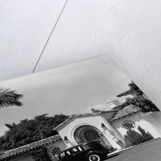 1930s car in circular driveway of tropical stucco spanish style home in sunset islands miami beach florida usa by Anonymous
