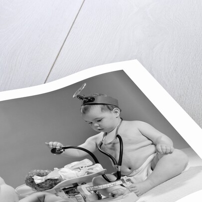 1960s two babies playing doctor and nurse with doll studio by Anonymous