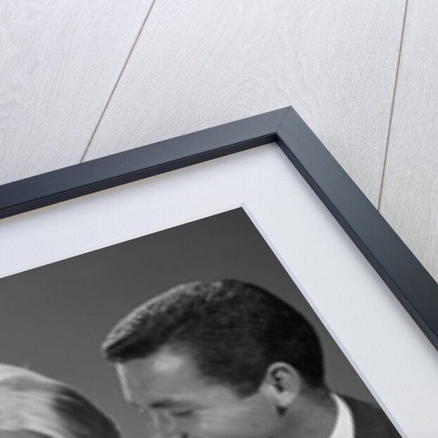 1960s happy mother and father smiling at their baby by Anonymous